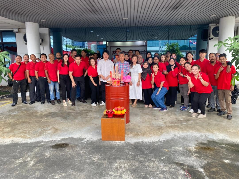 Large group of employees standing together for a team photo during the Hungry Ghost Festival at PrimeChem.