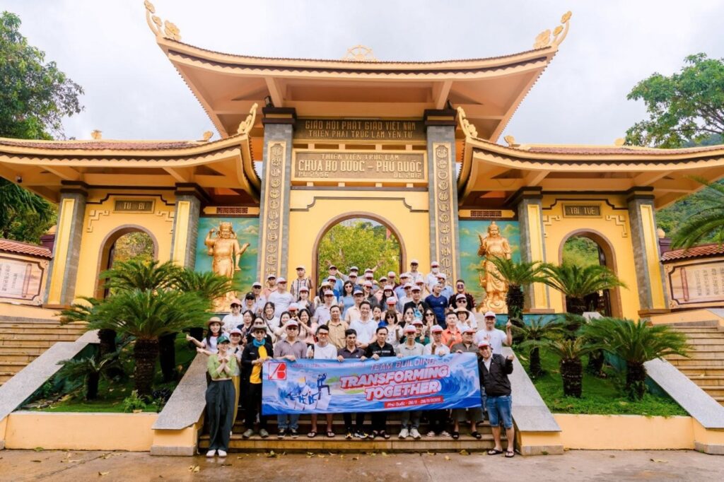 Team photo in front of the grand entrance gate of Ho Quoc Pagoda in Phu Quoc.