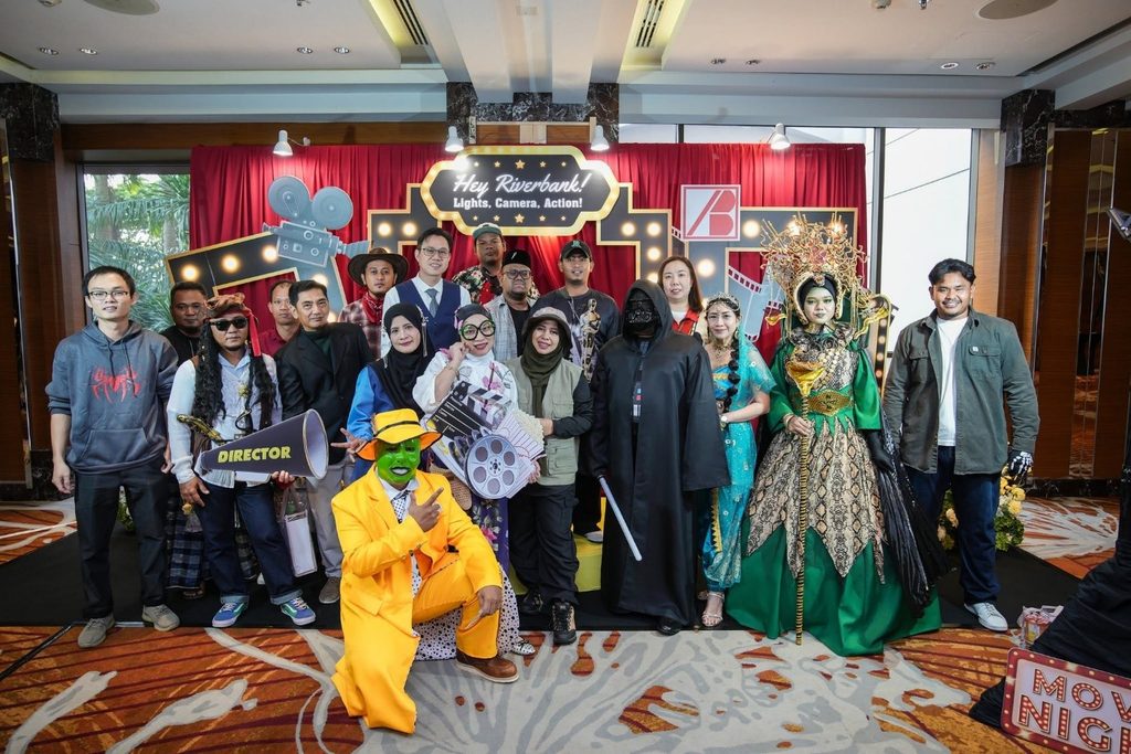 Attendees posing with movie-themed props and costumes at the Riverbank Annual Dinner 2026.
