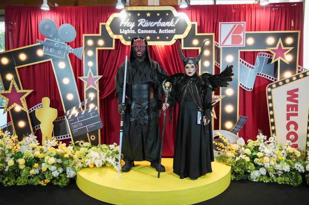 Two employees in elaborate Darth Maul and Maleficent costumes at the Riverbank Annual Dinner 2026 photo booth.
