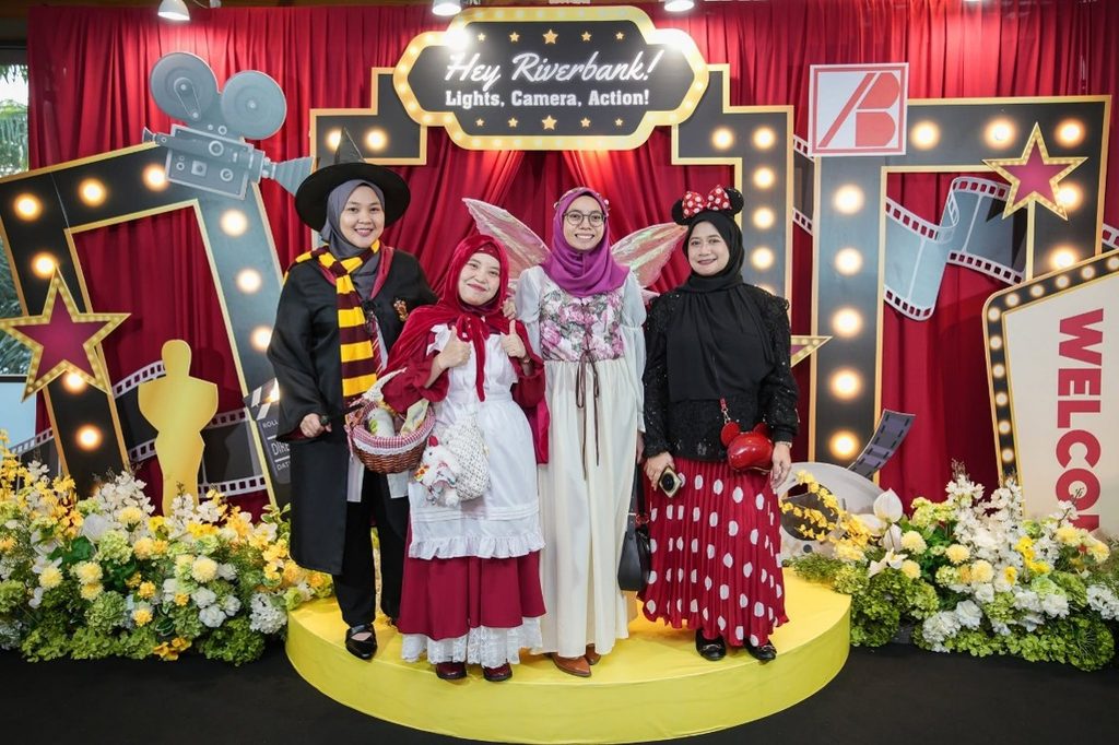 Four female employees dressed as a witch, Little Red Riding Hood, a fairy, and Minnie Mouse.